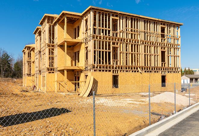 a close-up of temporary chain link fences enclosing a job site, signaling progress in the project's development in Jefferson